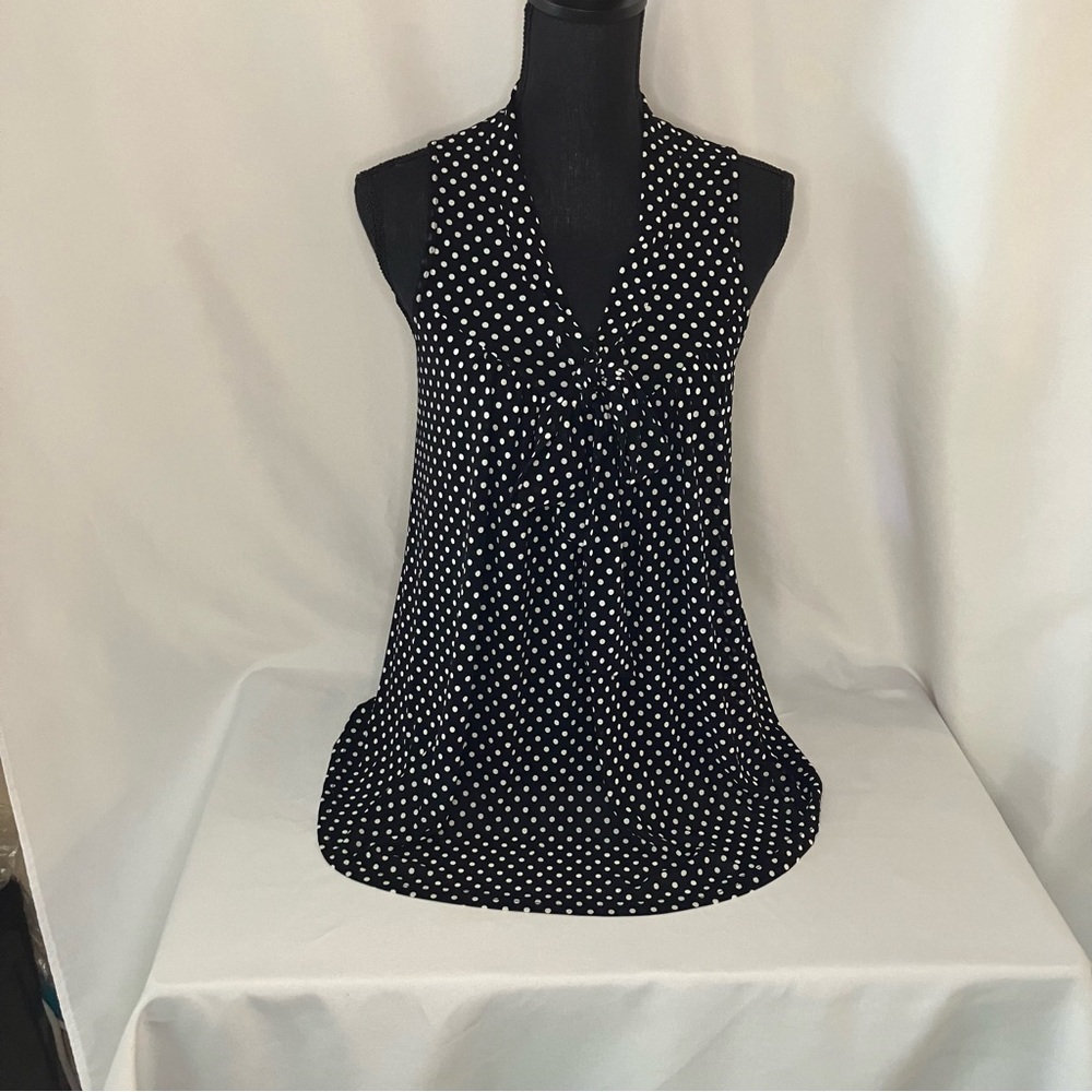 Women's top Ember Fashions black with white Polk dots with a feminine bow.